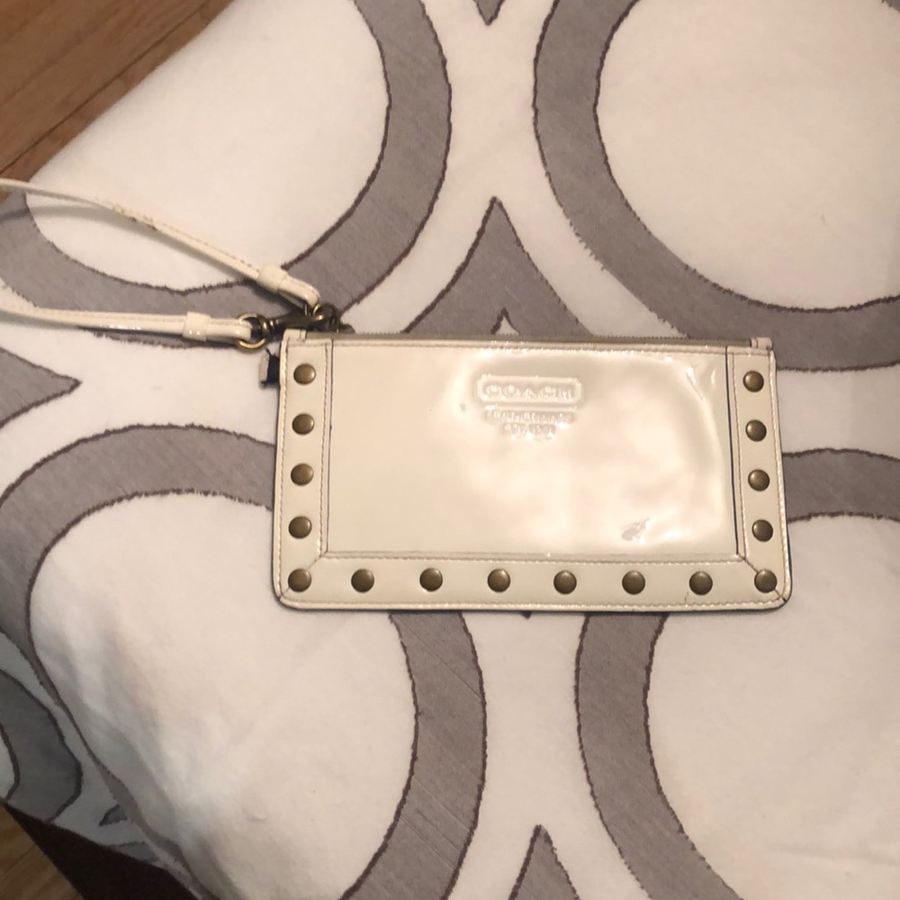 White patent leather wristlet with studs